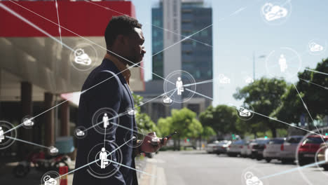 Animation-of-network-of-connected-icons-with-businessman-using-smartphone-walking-in-street