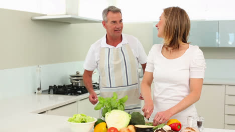 Mature-happy-couple-making-healthy-dinner-together