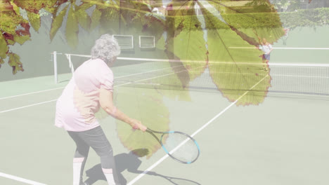Animation-of-glowing-light-over-happy-senior-couple-playing-tennis