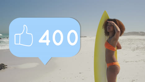 Animation-of-speech-bubble-with-thumbs-up-digital-icon-and-numbers,-woman-with-surfboard-on-beach