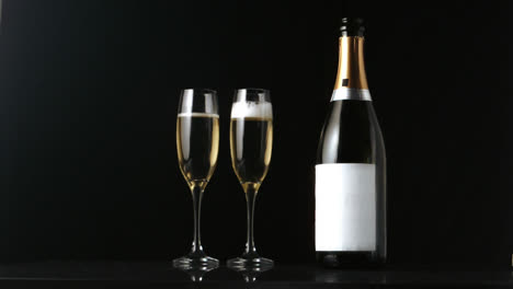 Animation-of-burning-document-and-falling-cork-over-champagne-bottle-and-glasses-on-black-background