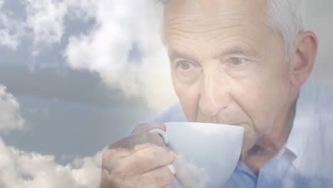 Animation-of-glowing-light-over-pensive-senior-man-drinking-tea
