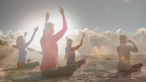 Animation-of-glowing-light-over-happy-senior-women-practicing-yoga-by-seaside