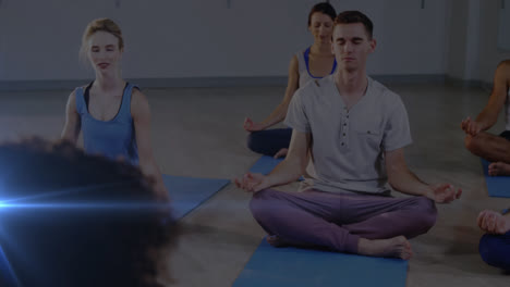 Animation-of-glowing-light-over-people-practicing-yoga