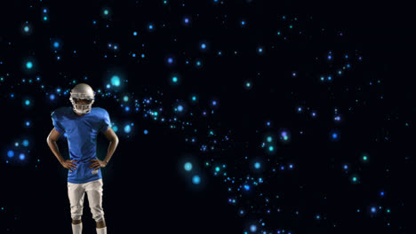 Animation-of-american-football-player-in-helmet-with-arms-crossed-over-glowing-blue-spots
