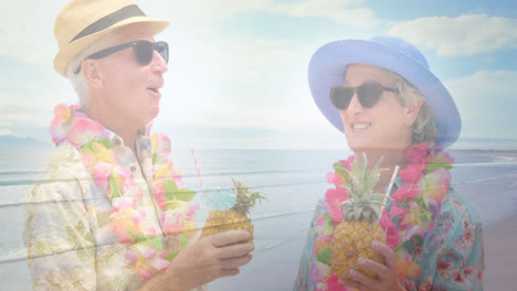 Animation-Von-Leuchtendem-Licht-über-Einem-Glücklichen-älteren-Paar,-Das-Am-Meer-Cocktails-Trinkt