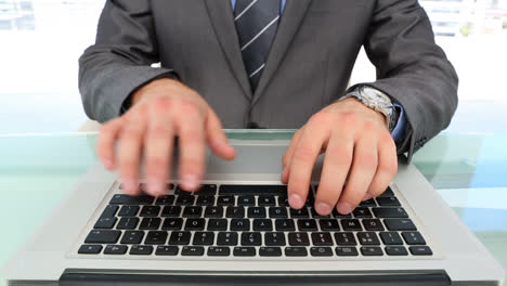 Businessmans-hands-typing-on-laptop