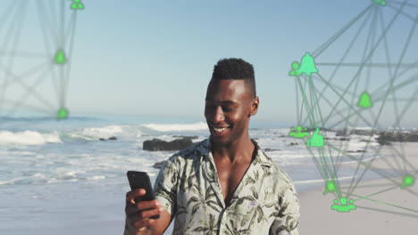 Animation-of-spinning-networks-with-social-media-digital-icons-over-man-using-smartphone-on-beach