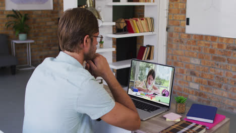 Caucasian-male-teacher-using-laptop-on-video-call-with-schoolgirl