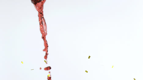 Animation-of-confetti-falling-over-red-wine-on-white-background