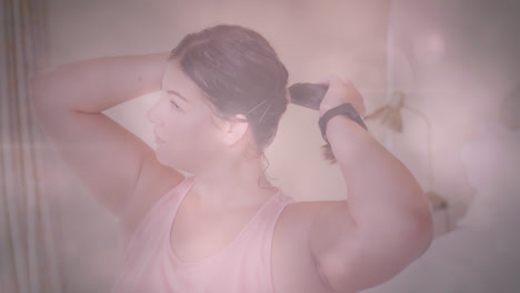 Animation-of-flickering-spots-of-light-over-woman-tying-her-hair-before-exercising-at-home
