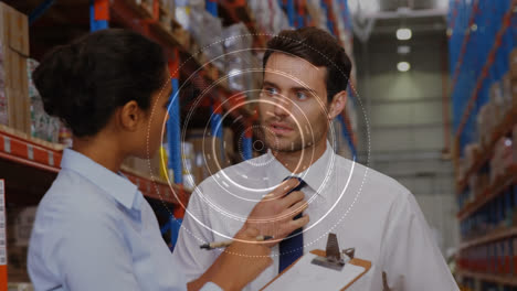Animation-of-scope-scanning-over-man-and-woman-working-in-warehouse