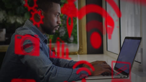 Mehrere-Digitale-Symbole-Schweben-Vor-Einem-Afroamerikanischen-Mann-Mit-Laptop