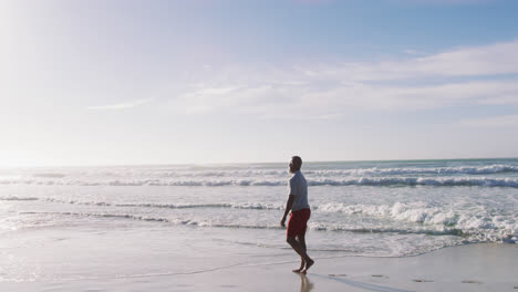 Senior-african-american-man-walking-at-the-beach