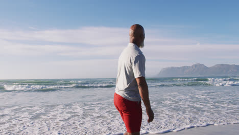 Senior-african-american-man-walking-at-the-beach