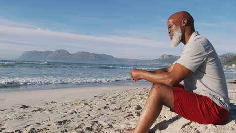 Senior-african-american-man-sitting-at-the-beach