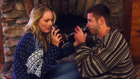 Happy-couple-celebrating-christmas-together-in-front-the-fireplace