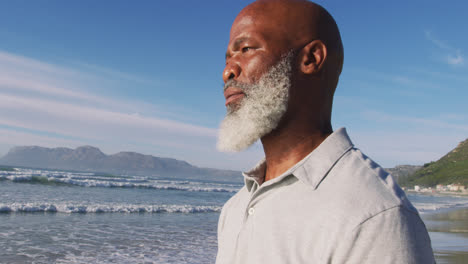 Senior-african-american-man-standing-at-the-beach,-admiring-the-view