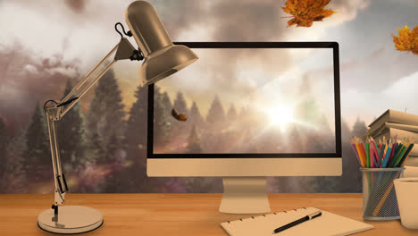 Animation-Von-Blättern,-Die-über-Laptop,-Computer-Und-Schreibtisch-Fallen
