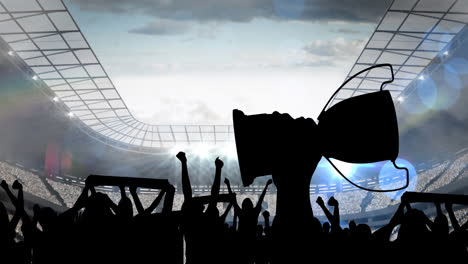 Animation-of-silhouettes-of-sports-fan-holding-cup-over-sports-stadium