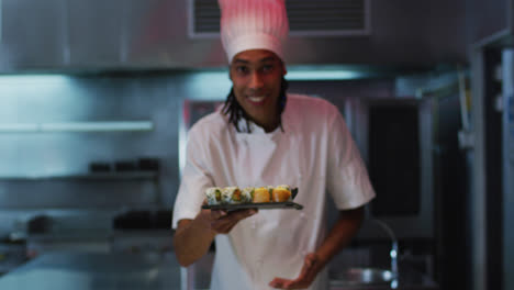 Chef-Masculino-De-Raza-Mixta-De-Pie-En-La-Cocina-Haciendo-Un-Buen-Plato-De-Sushi