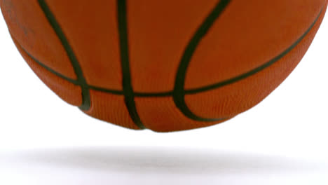 Animation-of-yellow-zigzag-lines-over-bouncing-basketball,-on-white-background