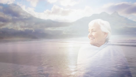 Animation-of-glowing-light-over-portrait-of-happy-senior-woman