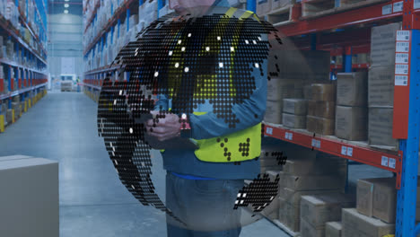 Spinning-globe-against-caucasian-male-worker-writing-on-clipboard-at-warehouse