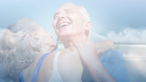 Animation-of-glowing-light-over-happy-senior-couple-dancing-by-seaside