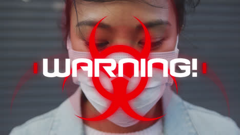 Animation-Einer-Textwarnung-Mit-Biogefährdungssymbol-über-Einer-Frau-Mit-Gesichtsmaske-Auf-Einer-Stadtstraße