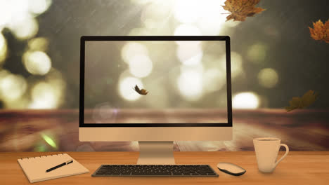 Animation-Von-Blättern,-Die-über-Laptop,-Computer-Und-Schreibtisch-Fallen