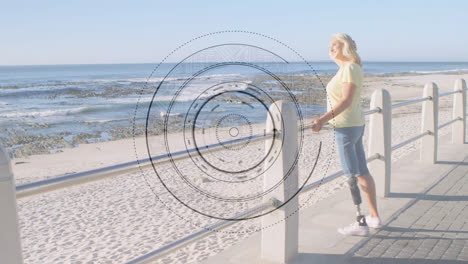Round-scanner-against-caucasian-senior-woman-with-prosthetic-leg-standing-on-the-promenade