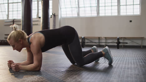 Seitenansicht-Einer-Fitten-Kaukasischen-Frau,-Die-Im-Fitnessstudio-Plank-Übungen-Durchführt