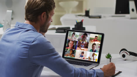 Caucasian-male-teacher-using-laptop-on-video-call-with-school-children