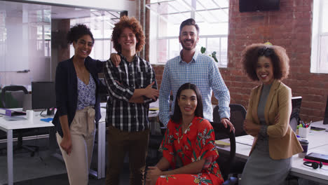 Group-of-diverse-business-colleagues-smiling-at-camera-in-office-room