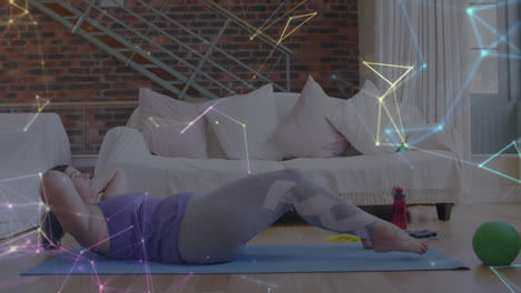 Glowing-network-of-connections-against-caucasian-woman-performing-crunches-exercise-at-home