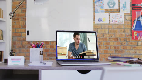 Male-student-learning-displayed-on-laptop-screen-during-video-call