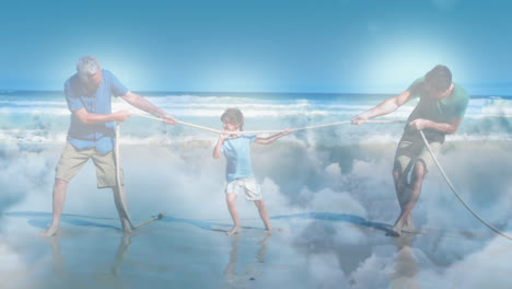 Animation-of-glowing-light-over-happy-senior-man-with-his-son-and-grandson-pulling-rope-by-seaside