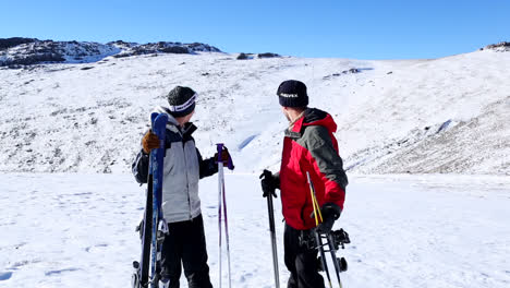 Active-couple-holding-skis-and-poles