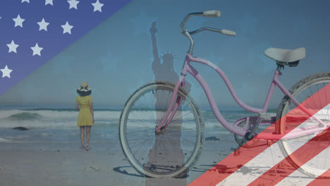 Animation-Einer-Amerikanischen-Flagge-Mit-Der-Freiheitsstatue-Und-Einer-Frau,-Die-Am-Strand-Spazieren-Geht