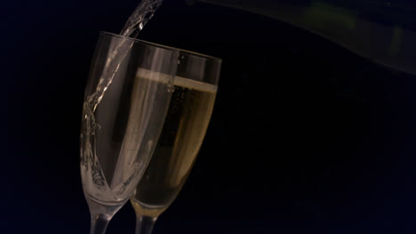 Animation-of-network-of-connections-over-champagne-glasses-on-black-background