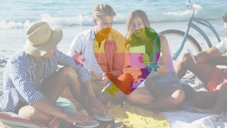 Animation-of-colourful-puzzle-pieces-heart-over-happy-people-on-thebeach