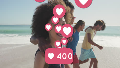 Animation-of-numbers-and-love-digital-icons-over-smiling-friends-on-beach