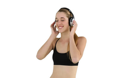 Fit-model-listening-to-music-and-smiling