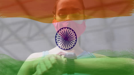 Animation-of-woman-wearing-face-mask-during-exercise-over-indian-flag