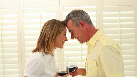Romantic-mature-couple-drinking-red-wine