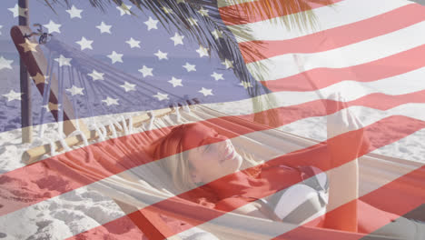 Animation-Einer-Amerikanischen-Flagge,-Die-über-Einer-Frau-In-Einer-Hängematte-Weht-Und-Ihr-Smartphone-Am-Strand-Benutzt