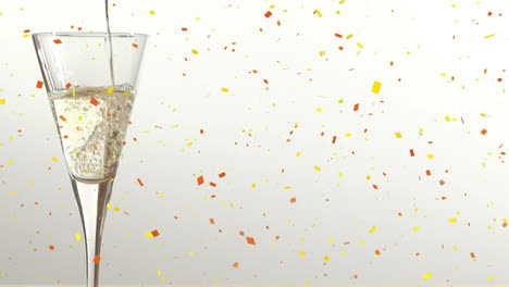 Animation-of-confetti-falling-over-champagne-glass-on-white-background