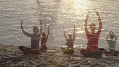 Animation-of-glowing-light-over-senior-women-practicing-yoga-by-seaside