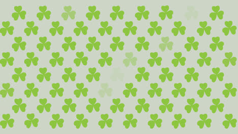 Digital-animation-of-multiple-clover-leaves-flickering-against-grey-background